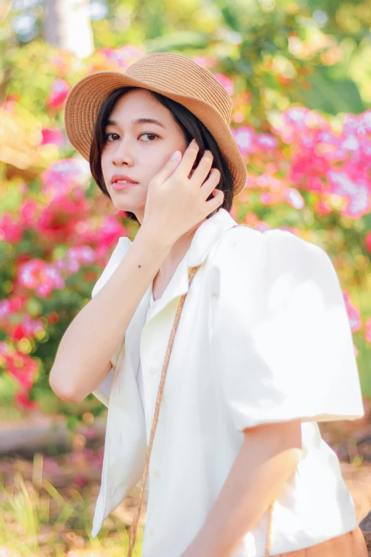 the young woman is wearing a straw hat