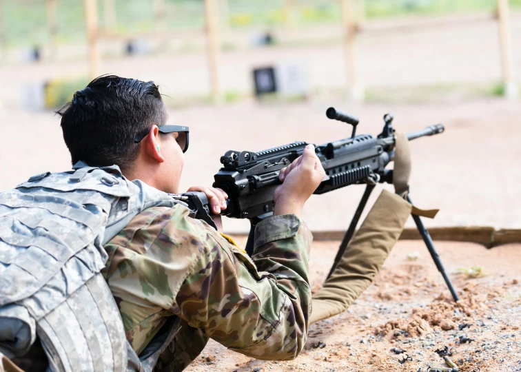 a soldier holding an arg over his shoulder