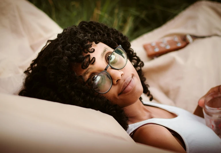 an attractive lady is laying on the couch