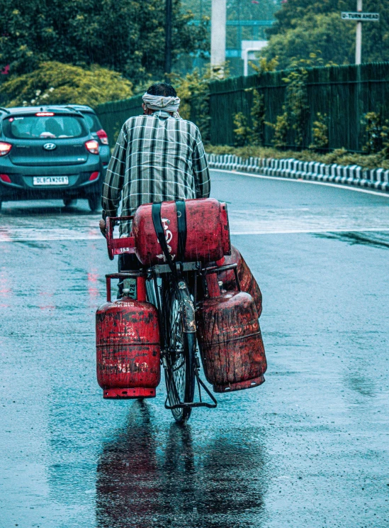 a man riding a bike with luggage on the back