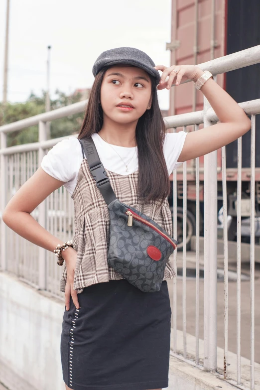 a girl standing by railing looking at soing