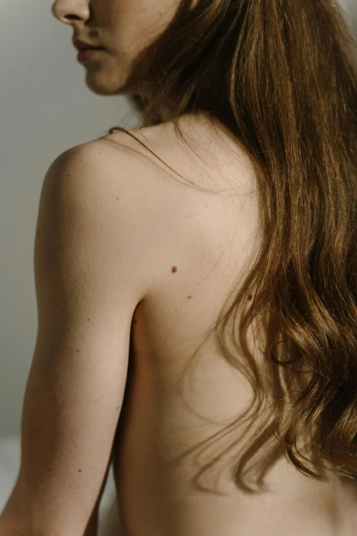 the back view of a  woman without a shirt