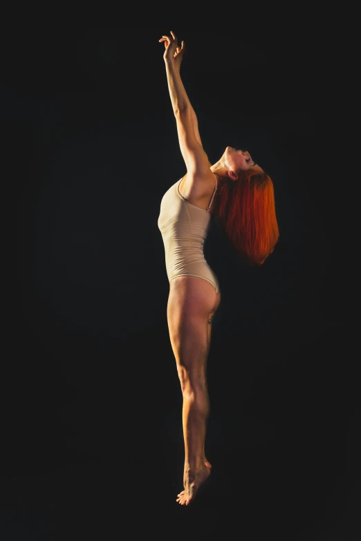 a girl in an orange headband is standing on one leg