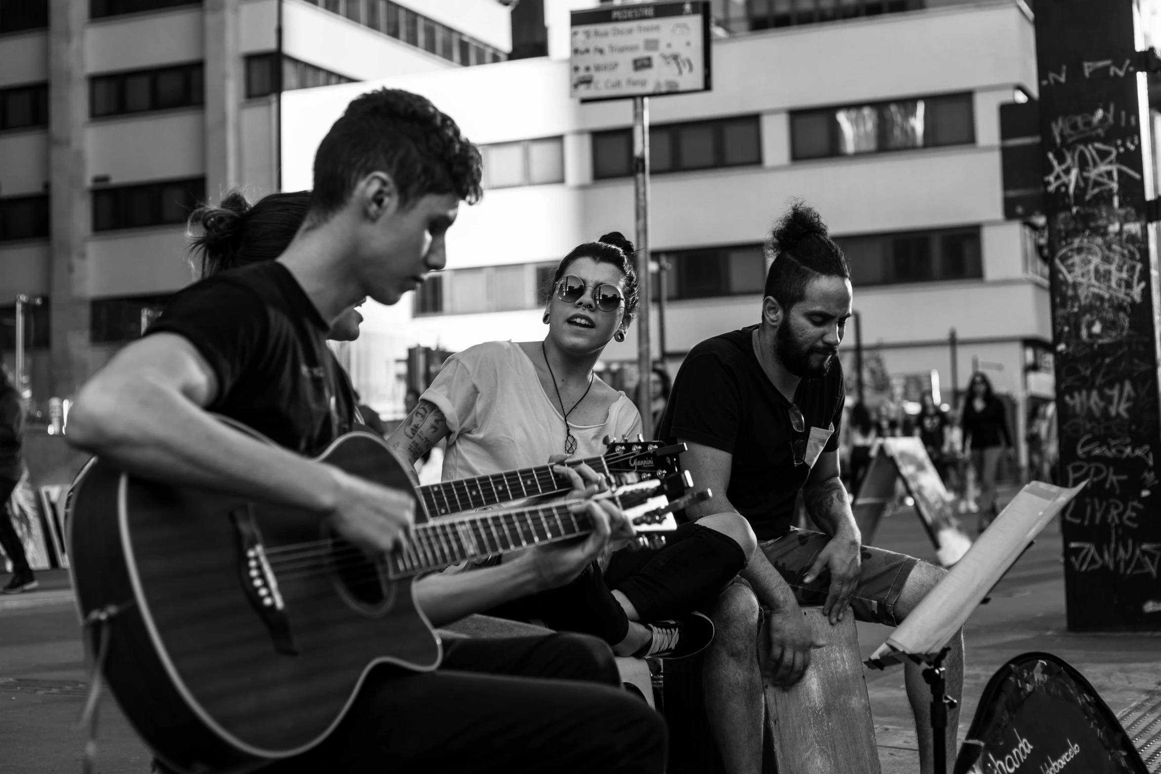 a group of people sitting on the side of a street