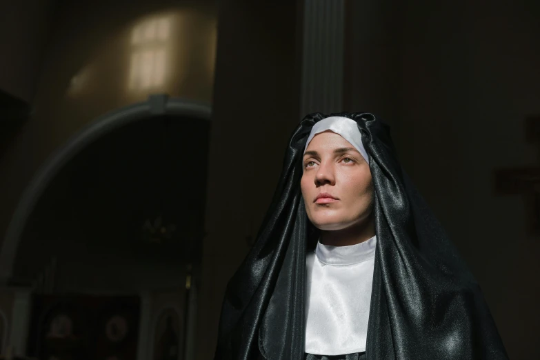 woman in religious robes dressed for mass in church