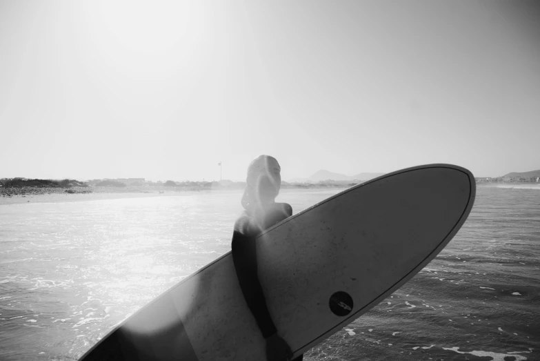 black and white po of a surfer waiting to catch the waves