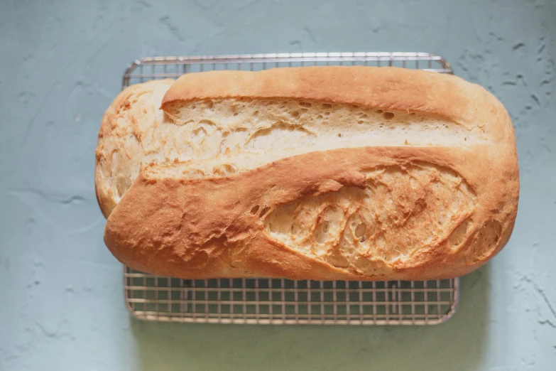 a loaf of fresh bread on top of a cooling rack