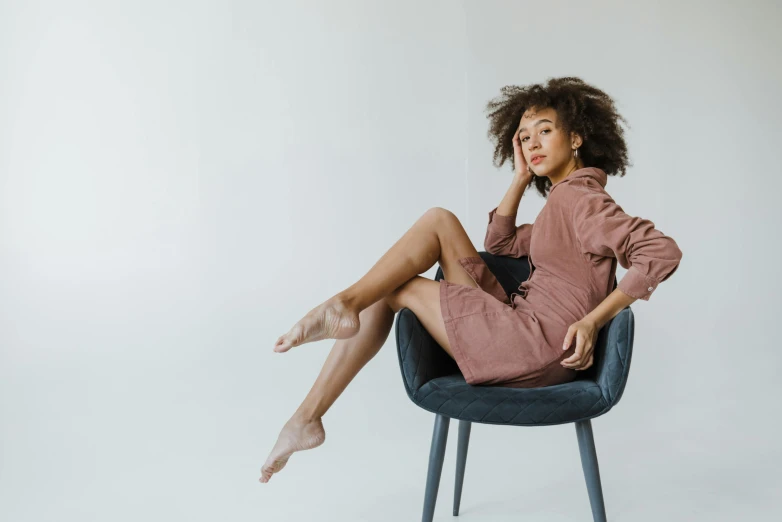 a woman with tights on posing in a chair