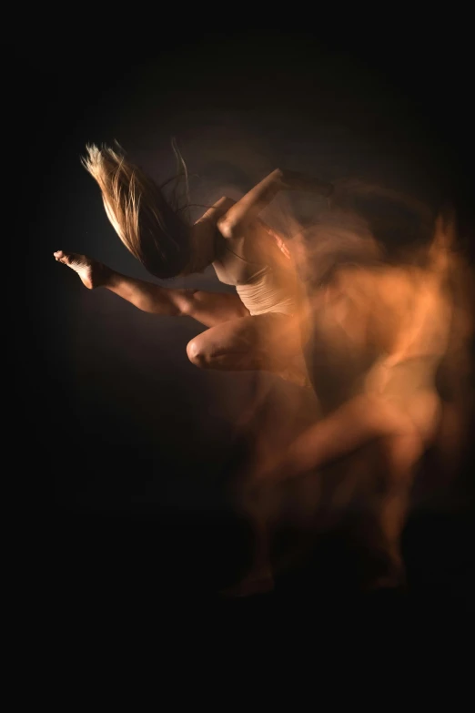 an attractive woman is dancing in the dark