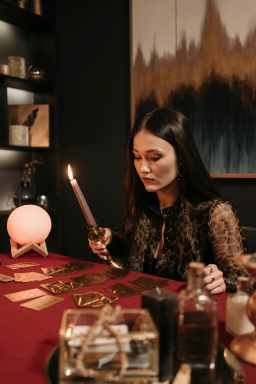 woman sitting at table looking at items in front of her