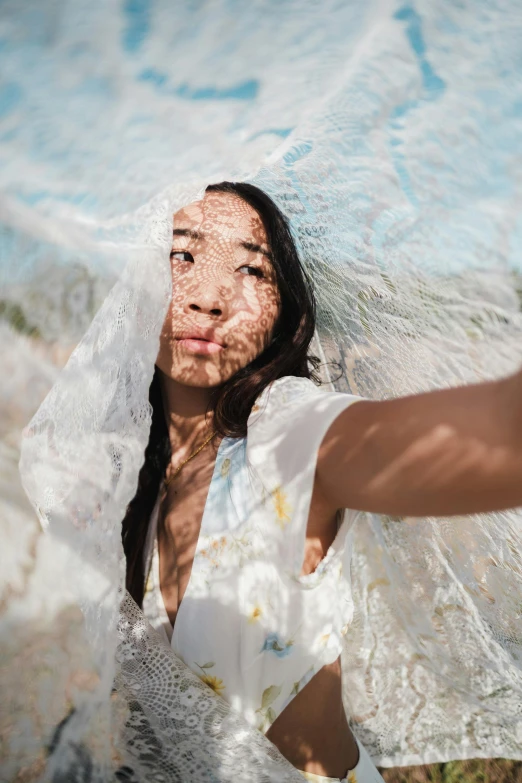 a woman taking a selfie with her wedding dress pulled back