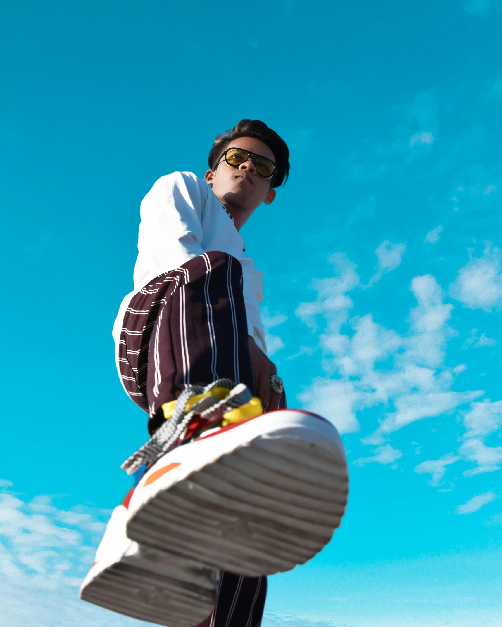 a man riding on the back of a skateboard through the air