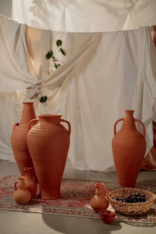 three pots are sitting on a carpet next to two baskets