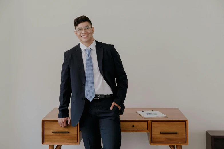 there is a man in glasses that is standing on the desk