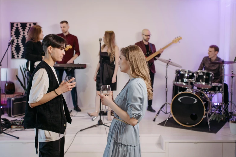 some young people are playing instruments and singing