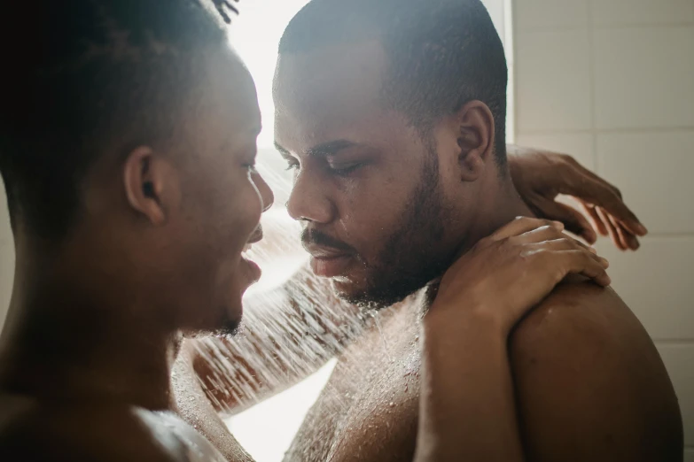 a man and woman looking at each other while in the shower