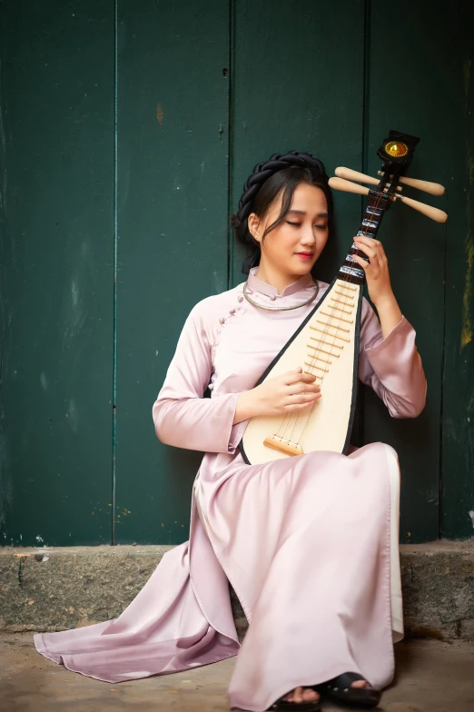 woman in oriental garb playing on her instrument