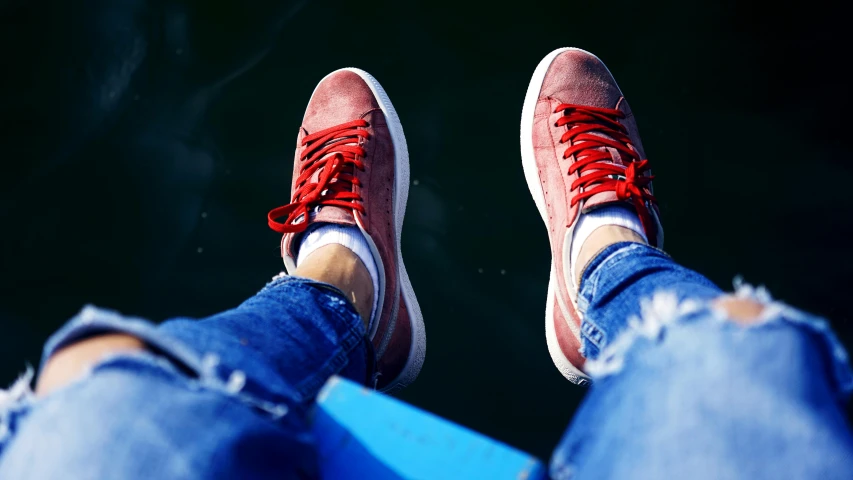 a person sitting down with their feet crossed