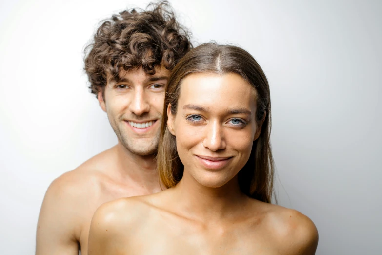 two young men are smiling while posing for the camera