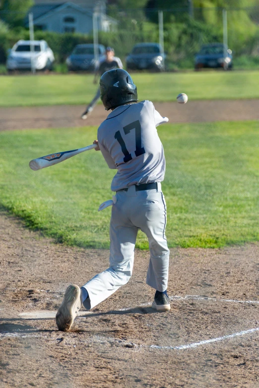 a boy in blue baseball uniform at bat