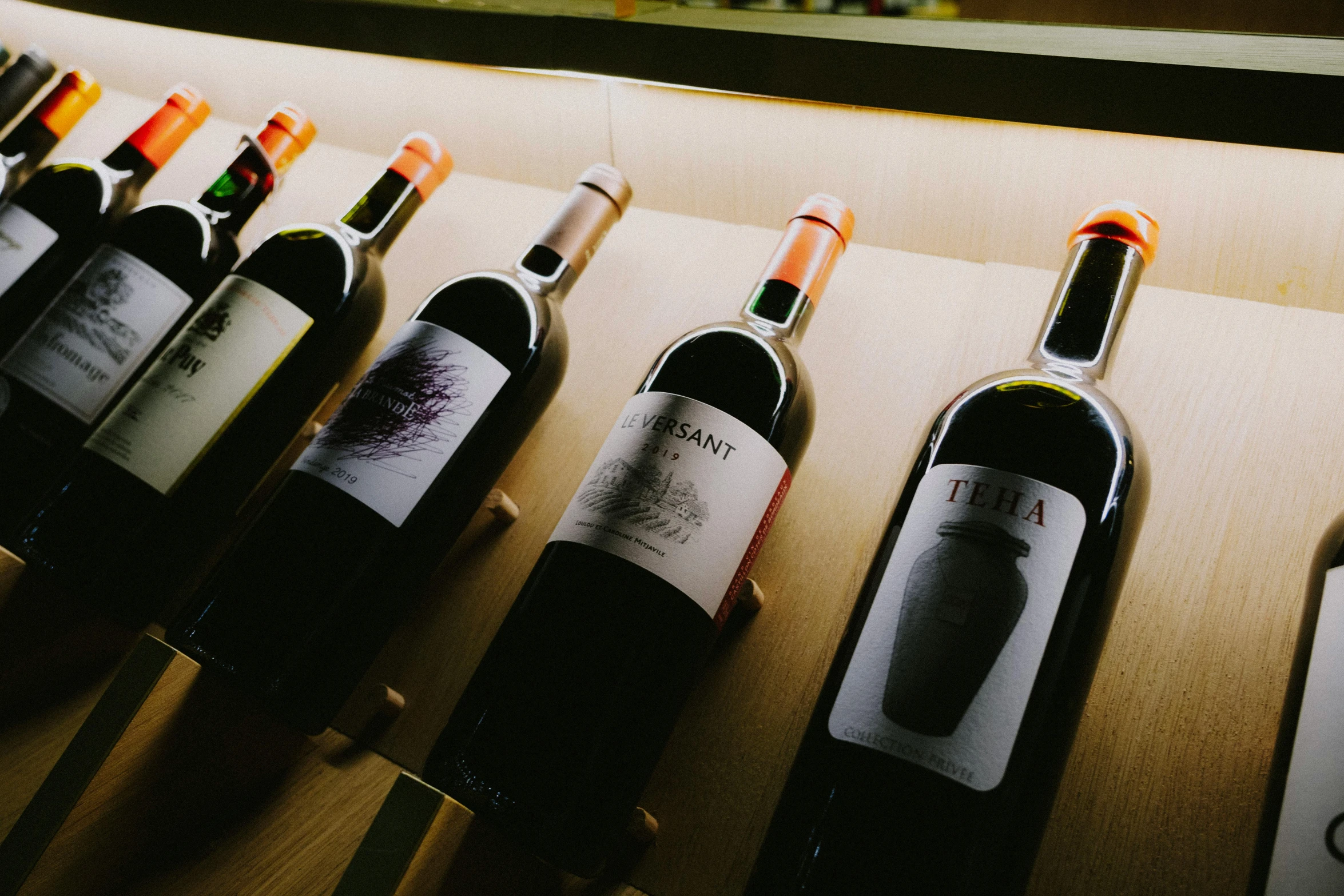 a group of bottles of wine sit side by side