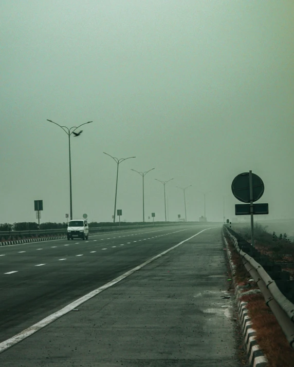 a view of an empty street in the foggy day