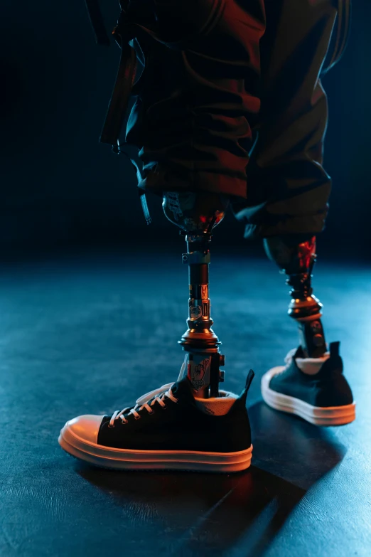 a person standing on a black floor and wearing black sneakers