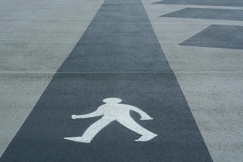 a man walking down a runway near traffic signals