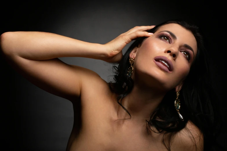 a woman is posing for the camera wearing gold jewelry