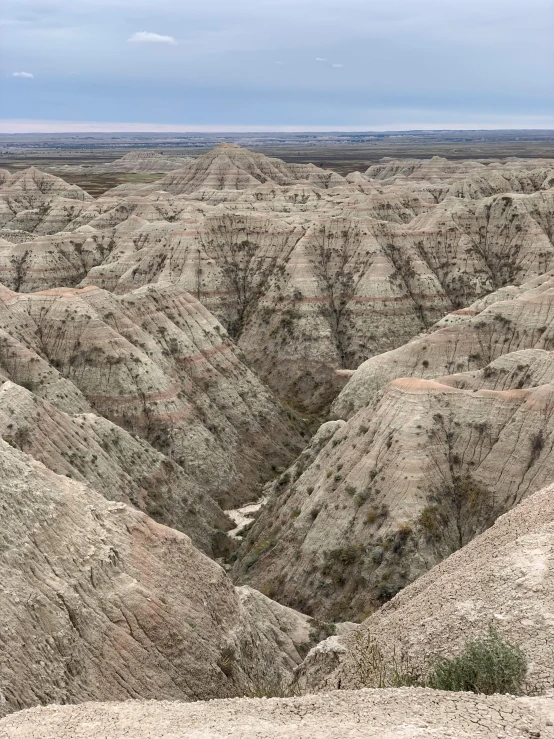 a valley that has a large formation of rocks and sand in the middle