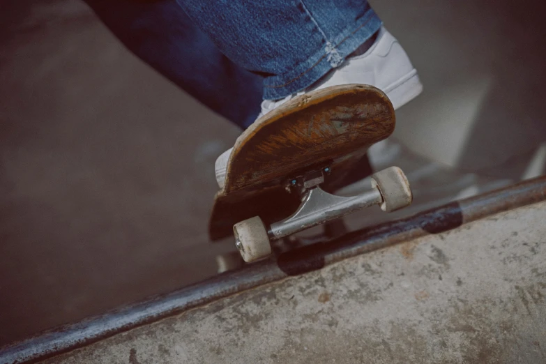 the legs of a person riding on a skateboard
