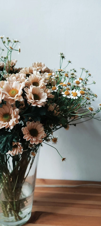 a clear vase with lots of flowers in it