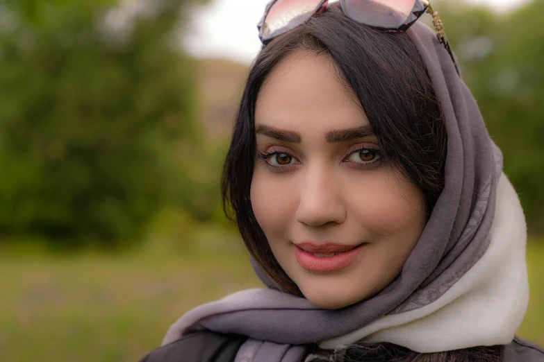 a woman with glasses looking off into the distance