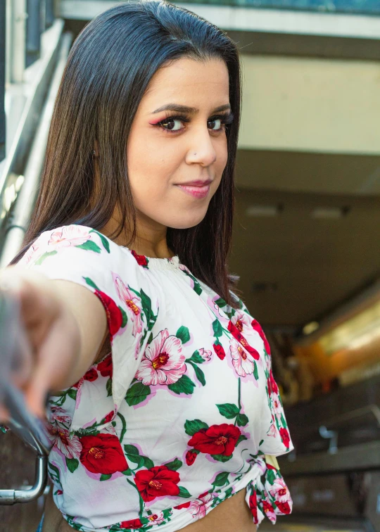 young lady with brown eyes pointing finger at soing