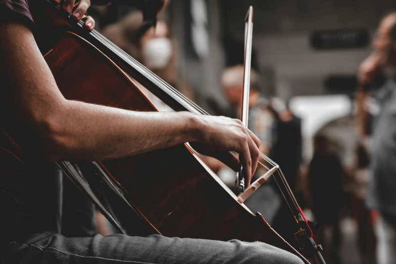 a close - up of a violin player sitting in a chair