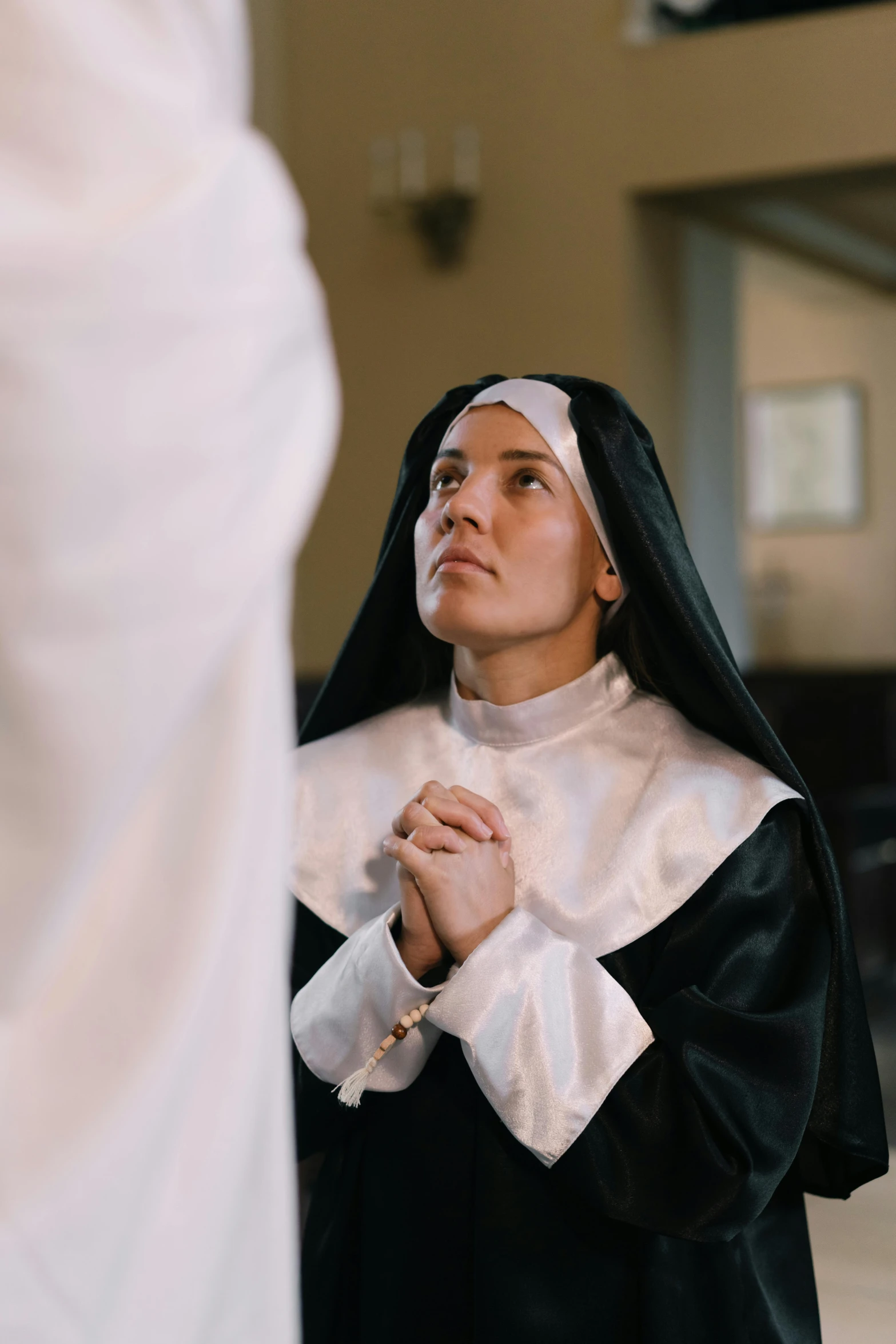 a woman wearing a black and white outfit is dressed in a black and white hoodie