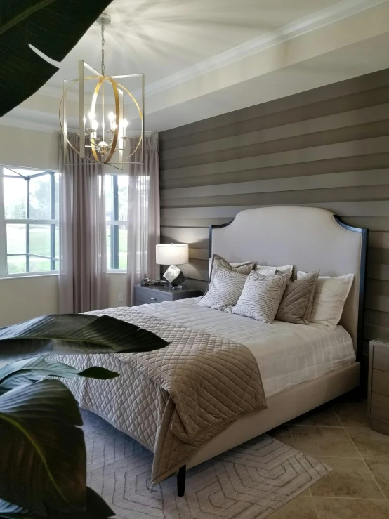 a neatly made bed with white and beige pillows