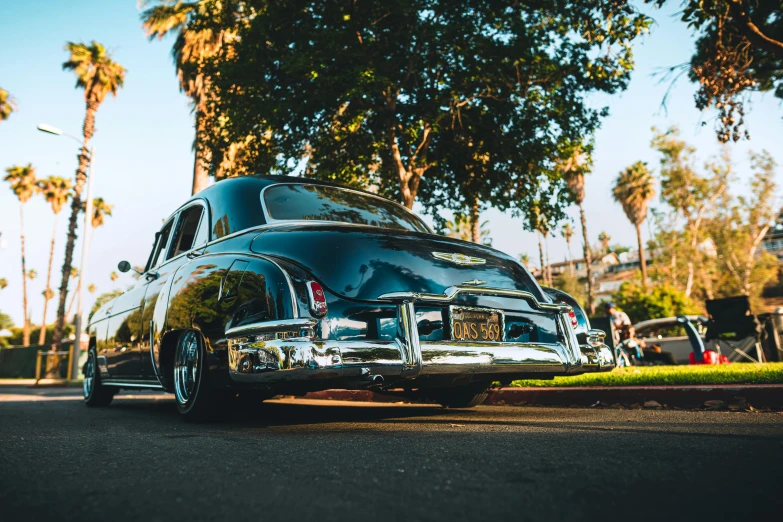 a silver car parked next to a street on a sunny day