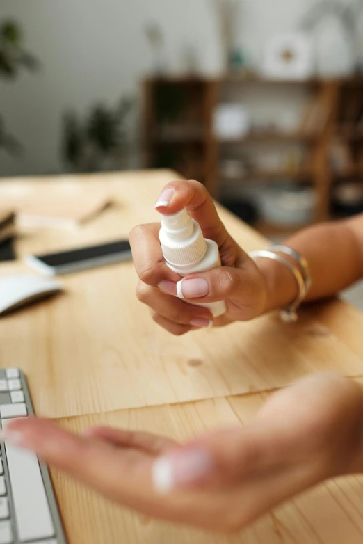 someone holding a bottle sitting on top of a table