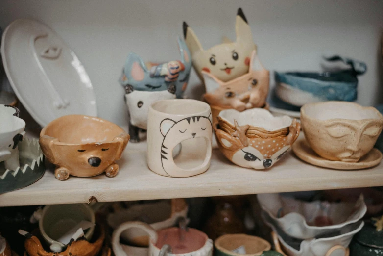 a collection of ceramic items on a shelf