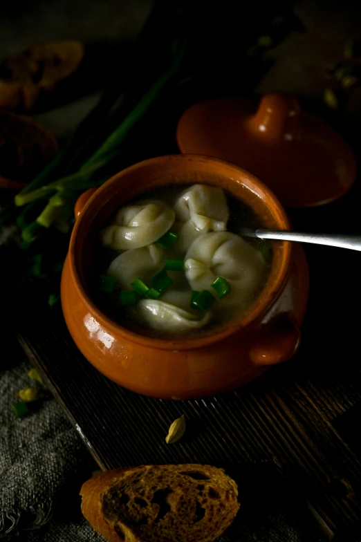 a bowl of dumplings with a spoon in them