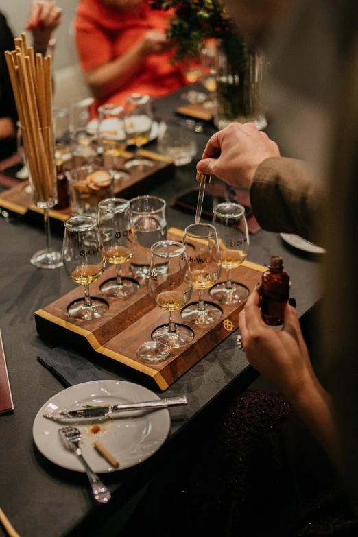 people are sitting at a table with empty wine glasses