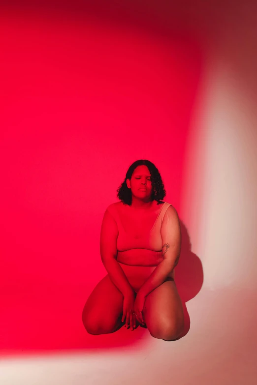 a woman is posing for a po in front of a pink background