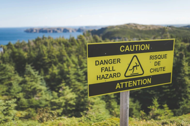 a warning sign sits on top of a mountain