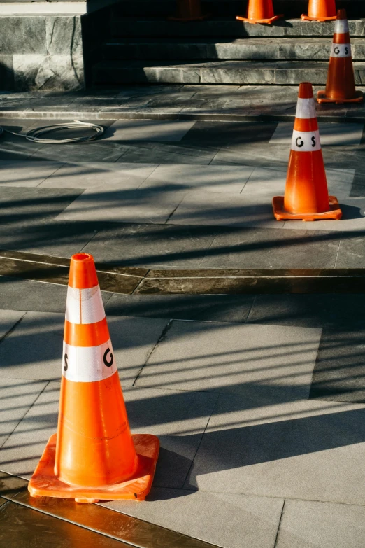 several traffic cones sitting on the ground next to some steps