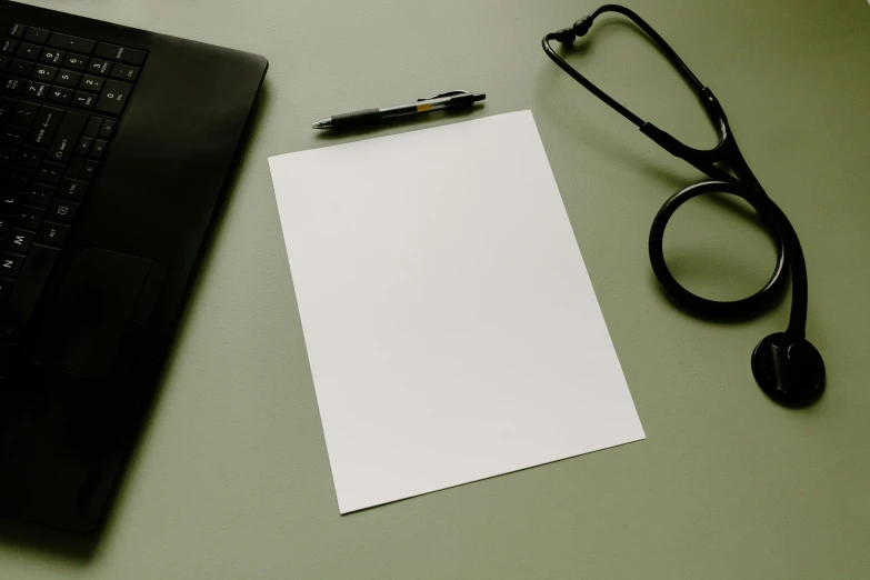 a pen, glasses and a note pad on a desk