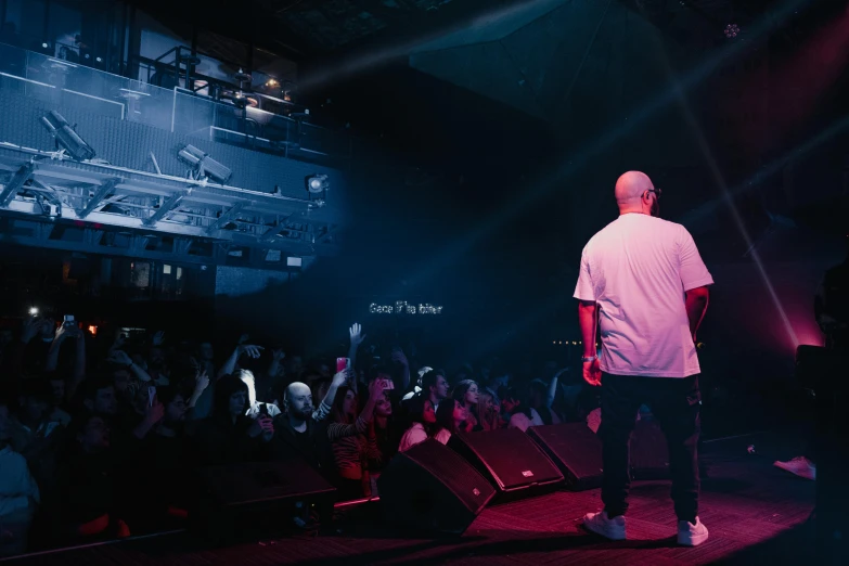 man looking at audience in front of stage