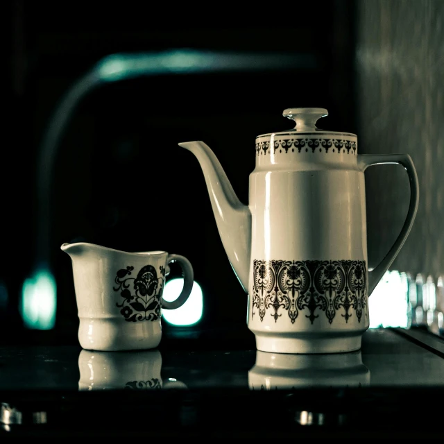 a tea kettle and sugar bowl on top of a counter