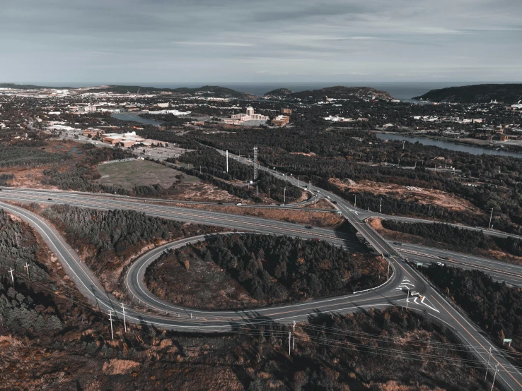 an aerial view of a highway and trees