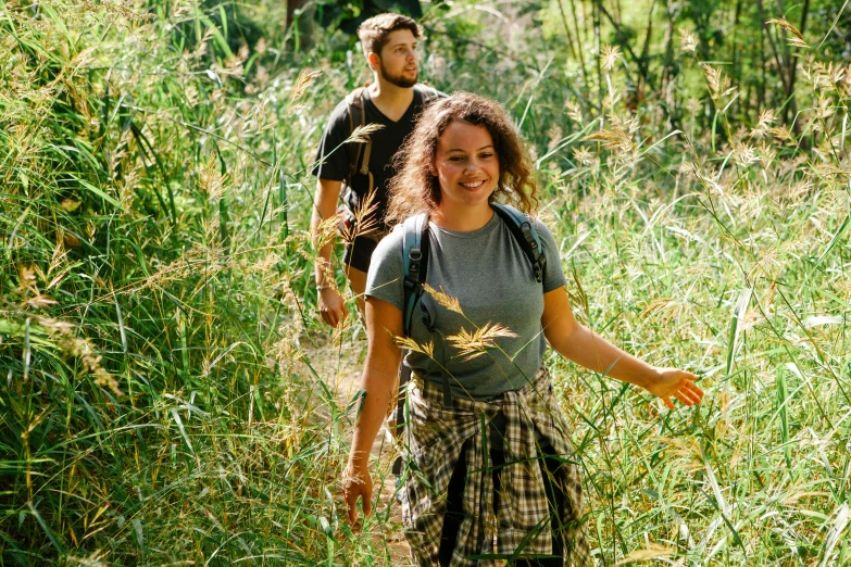 an image of a man and a woman walking through a field